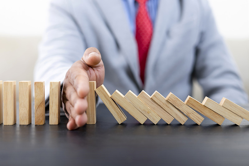 商人把木块放在塔上概念风险控制,规划和战略的业务。替代风险概念,风险使业务增长的概念与木块图片下载